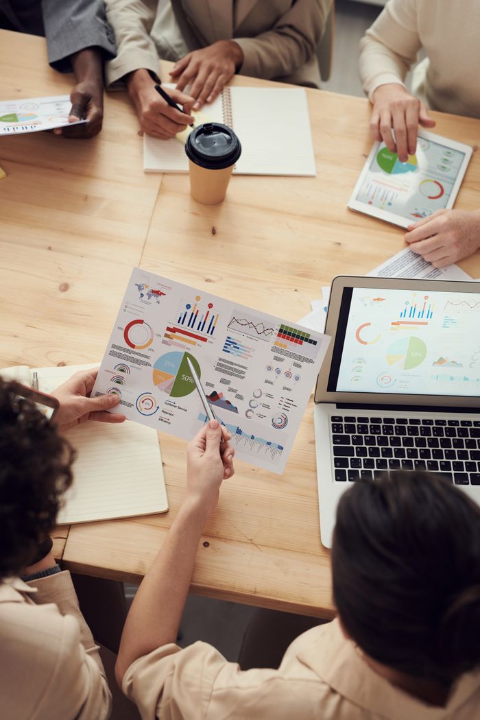 Mastering the First Impression: Your intriguing post title goes here Colleagues collaborate on data analysis at a team meeting with charts and laptop.