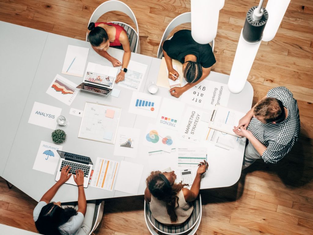 Diverse team collaborating on marketing strategy in a modern office setting.